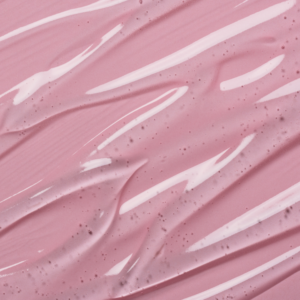 Macro de la texture gelée rose pâle du Masque Nuit Éclat, lisse et parsemée de fines particules